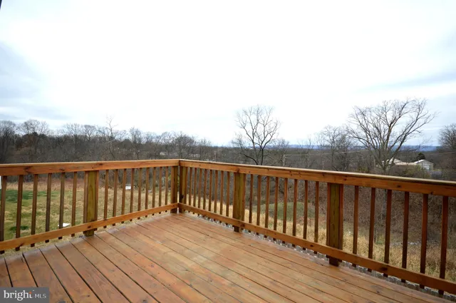 a balcony with wooden floor and fence