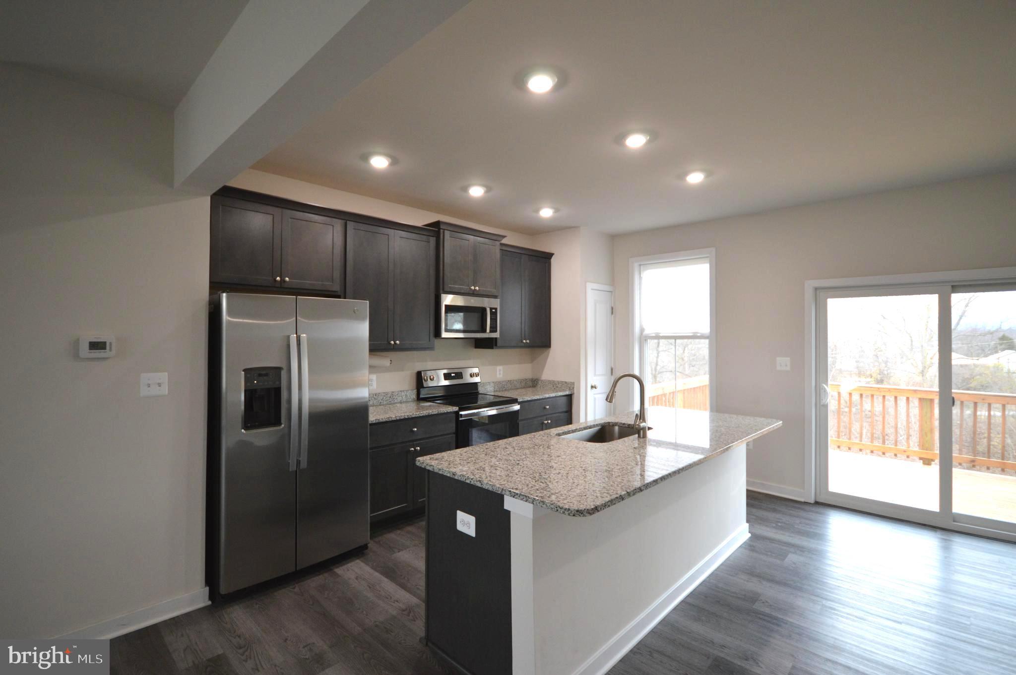 44 Marineris Circle Martinsburg, WV 25405 - Photo 3 of 19 a kitchen with kitchen island a sink stainless steel appliances and window