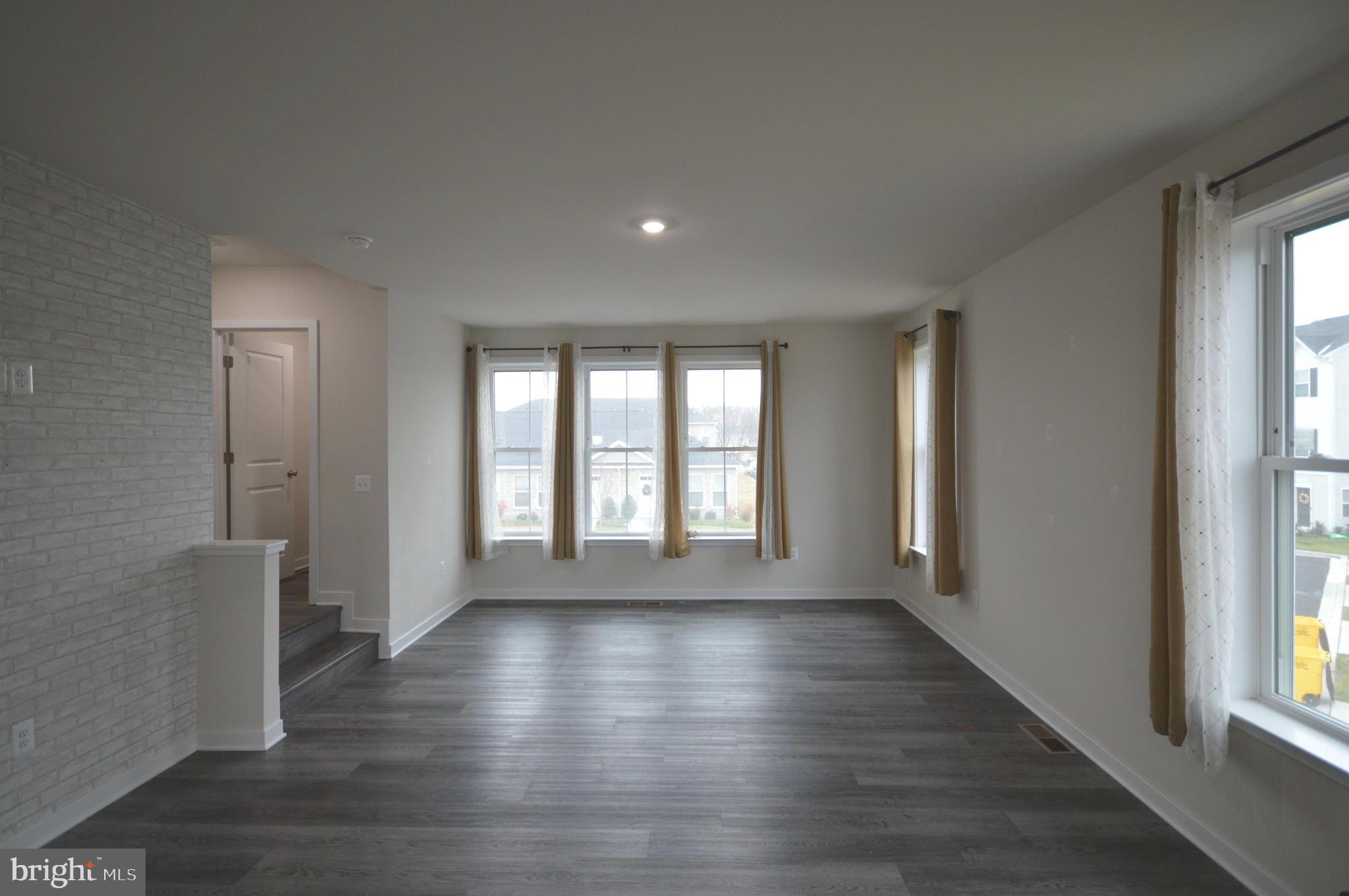 44 Marineris Circle Martinsburg, WV 25405 - Photo 5 of 19 a view of an empty room with wooden floor and a window
