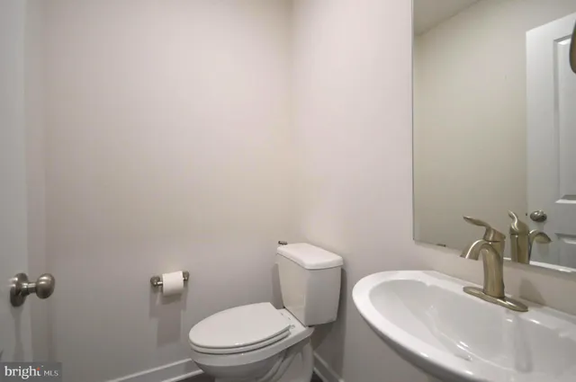 a white toilet sitting next to a bathroom sink