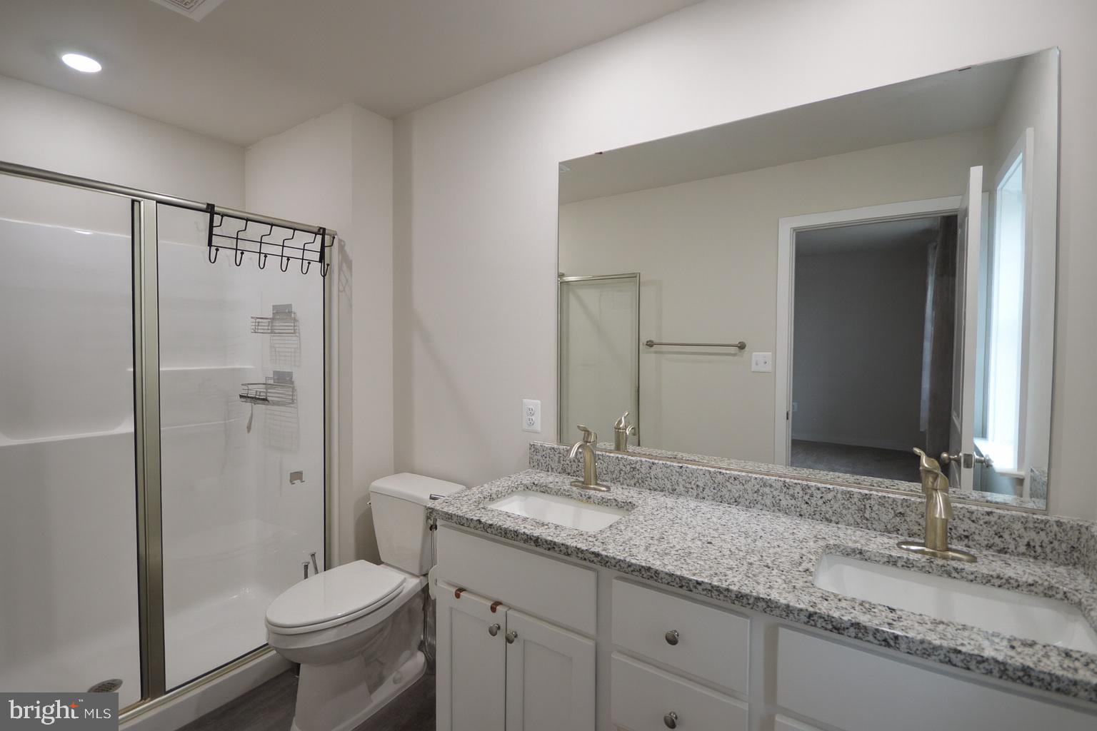 44 Marineris Circle Martinsburg, WV 25405 - Photo 10 of 19 a bathroom with a granite countertop sink toilet and shower
