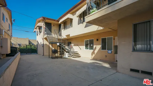 a front view of a building with parking area