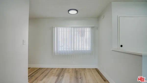 a view of a livingroom with a ceiling fan and wooden floor