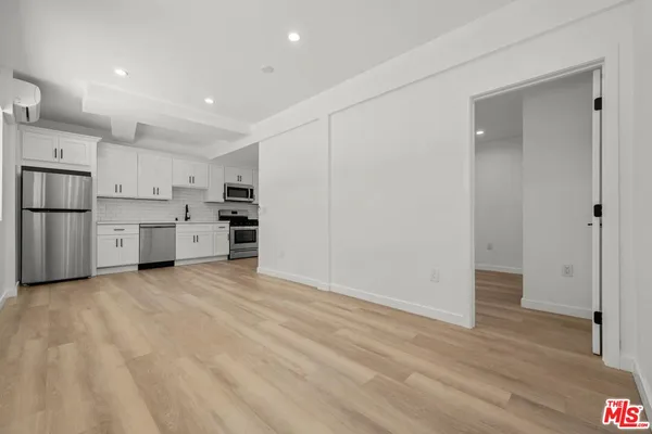 a kitchen with stainless steel appliances a refrigerator and a stove top oven