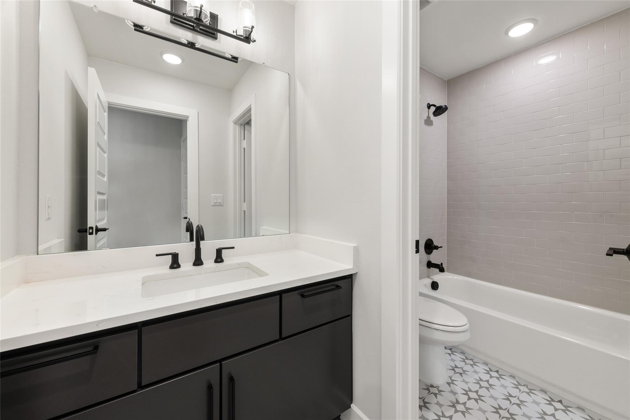 6216 Bower Well Road Austin, TX 78738 - Photo 26 of 31 a bathroom with a sink a toilet a tub and shower
