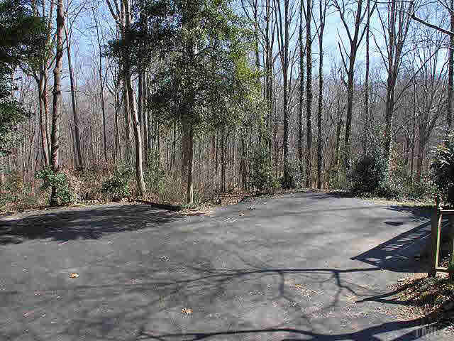 7904 Netherlands Drive Raleigh, NC 27606 - Photo 14 of 15 Tons of parking area out back or room to add a garage. Parking Lot/Garage