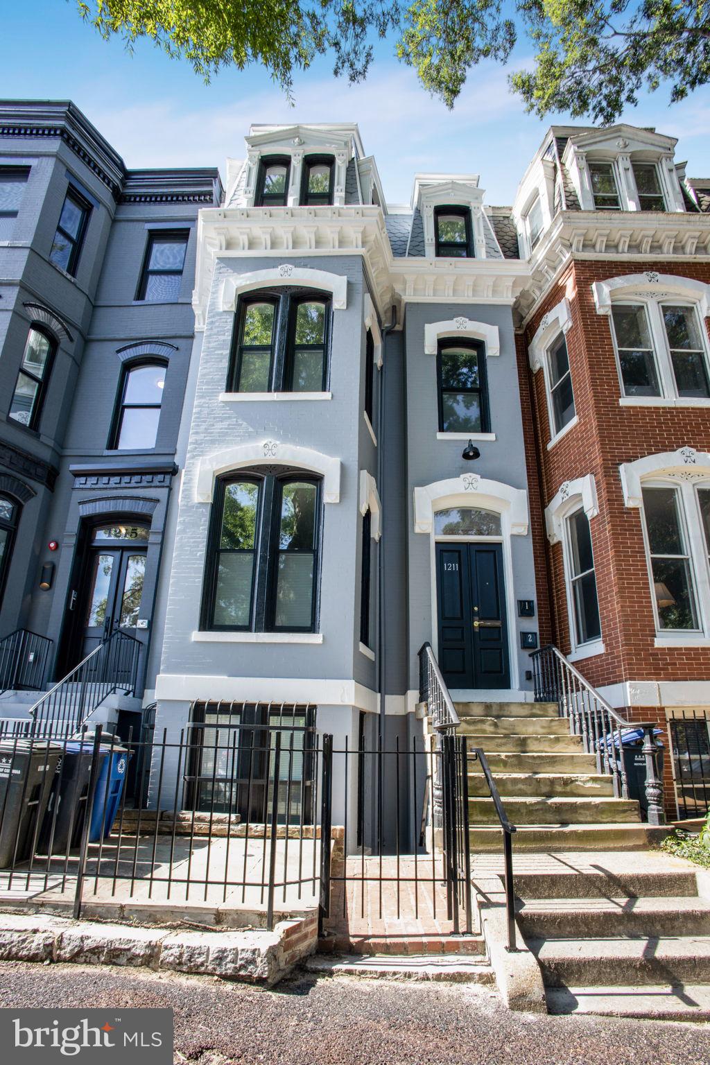 a front view of a residential apartment building with a yard