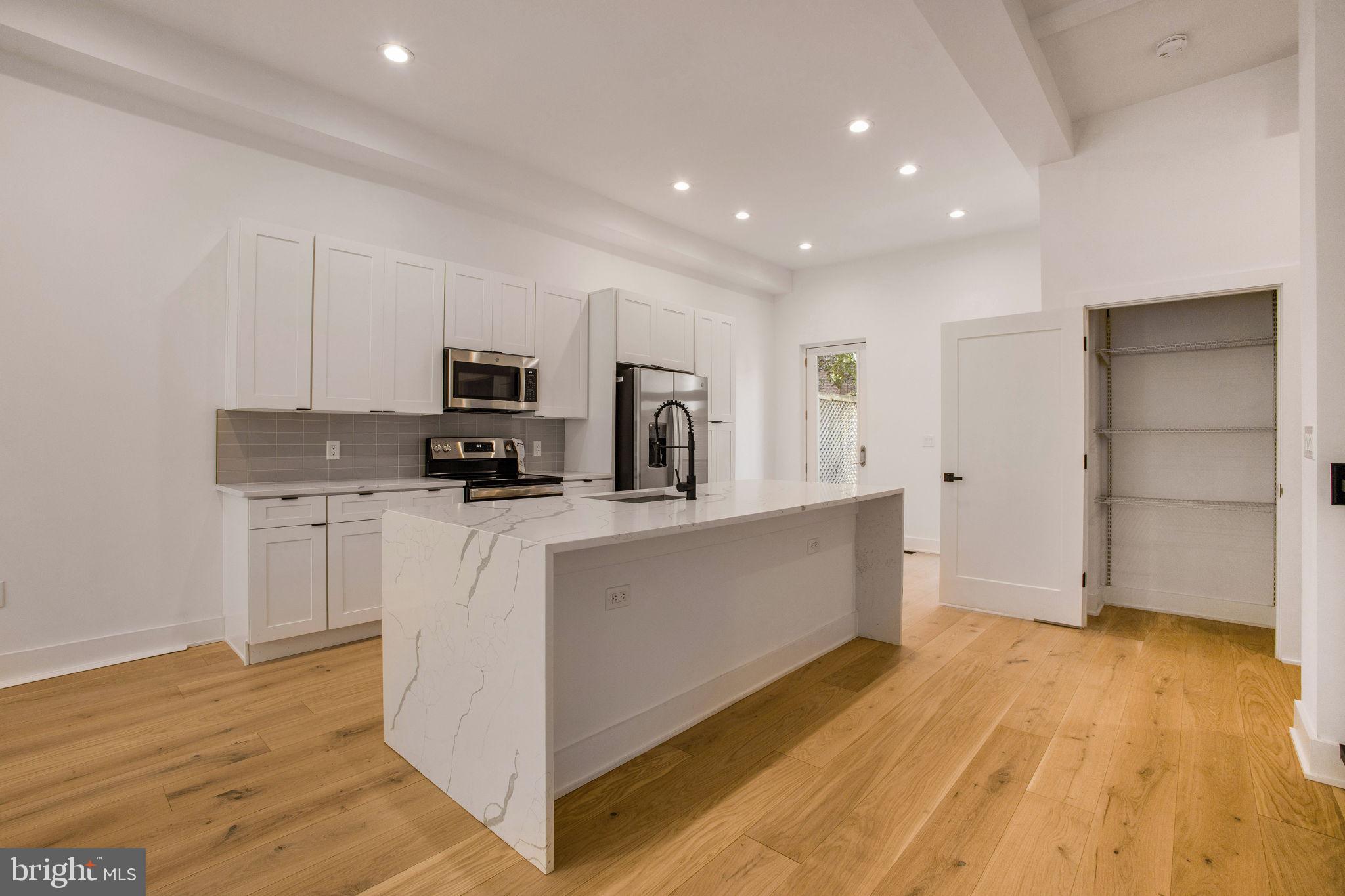 1211 Rhode Island Avenue Northwest, Unit 1 Washington, DC 20005 - Photo 5 of 24 a kitchen with stainless steel appliances granite countertop a stove a sink and a refrigerator