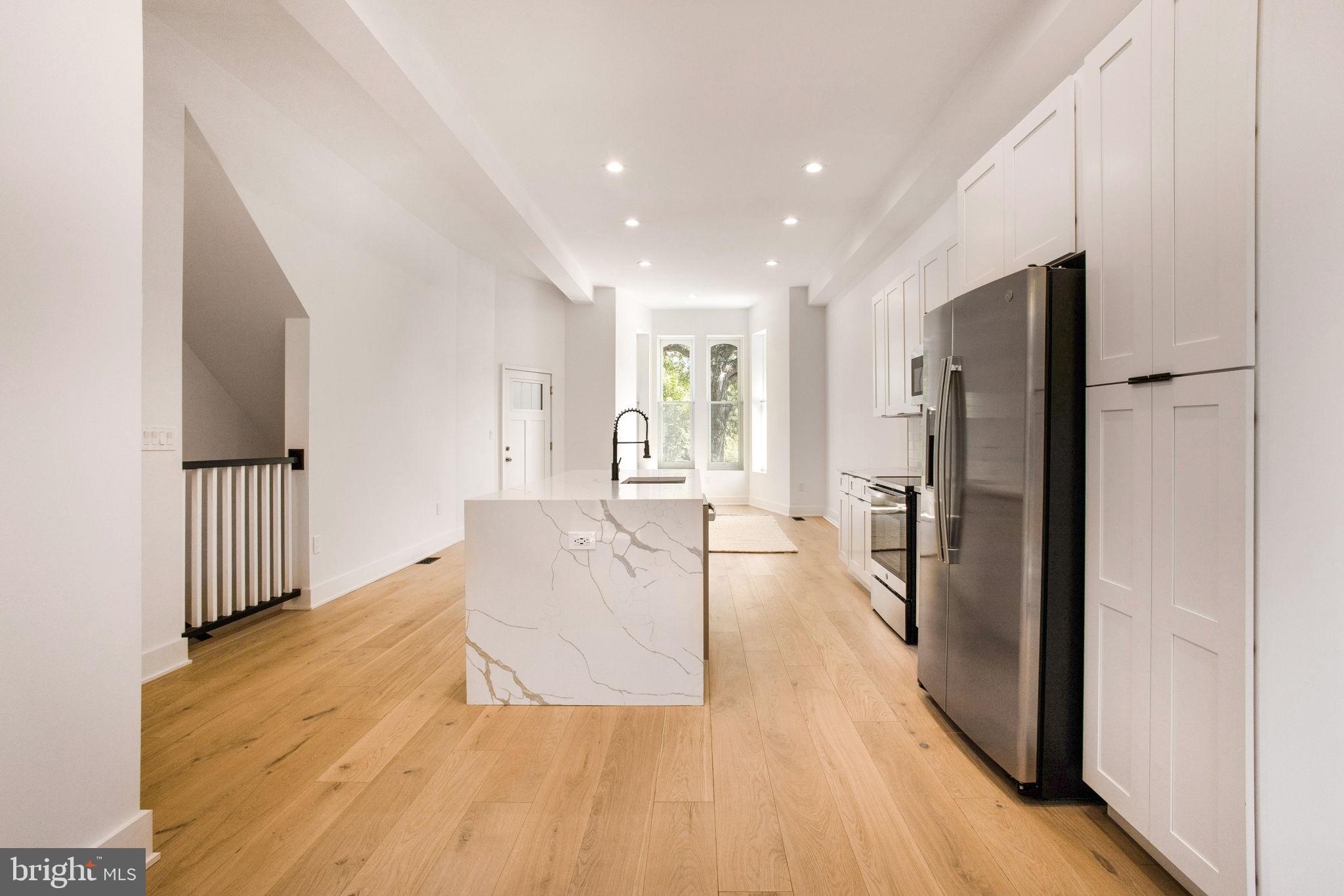1211 Rhode Island Avenue Northwest, Unit 1 Washington, DC 20005 - Photo 9 of 24 a view of a kitchen with a refrigerator and windows