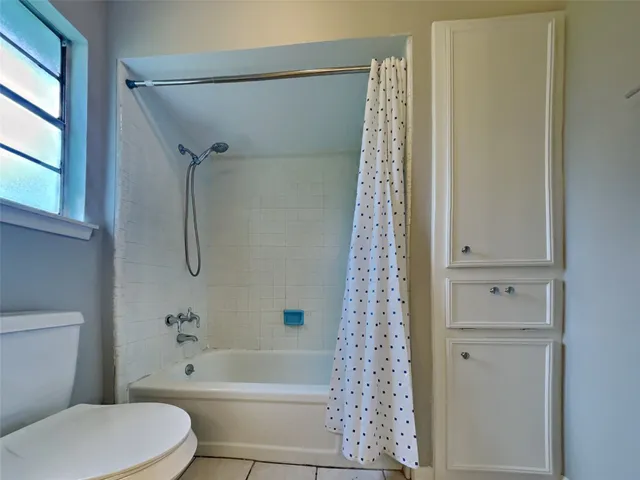 a bathroom with a toilet and shower