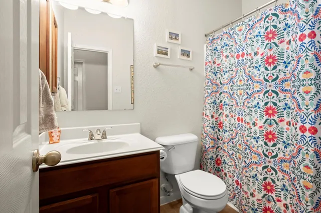 a bathroom with a sink toilet and mirror