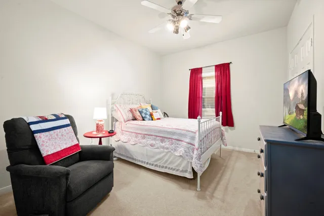 a bedroom with a bed and flat screen tv