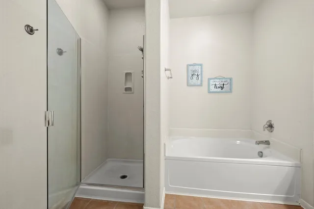 a bathroom with a bathtub and shower