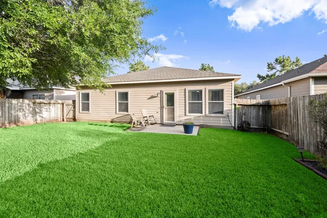 a view of a house with backyard porch and furniture