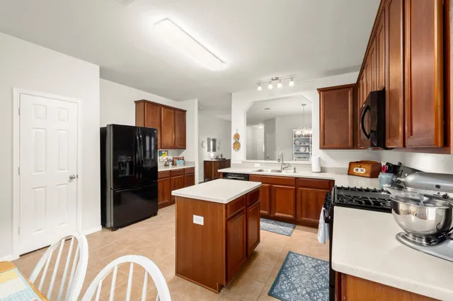 a kitchen with a refrigerator sink and stove