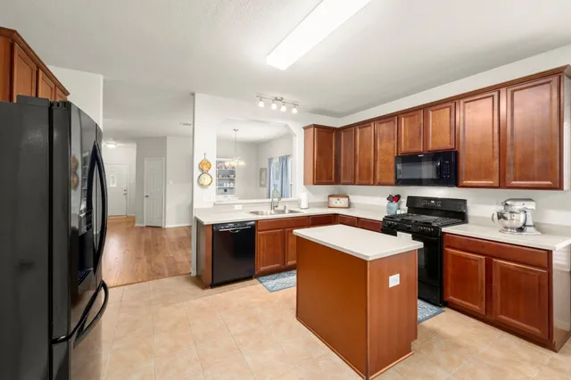 a kitchen with a stove sink and a refrigerator