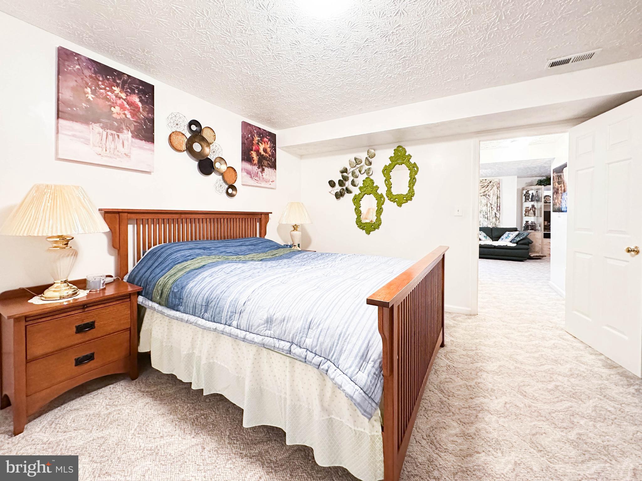 3206 Shadow Park Drive Laurel, MD 20724 - Photo 23 of 28 a bedroom with a bed and a painting on the wall