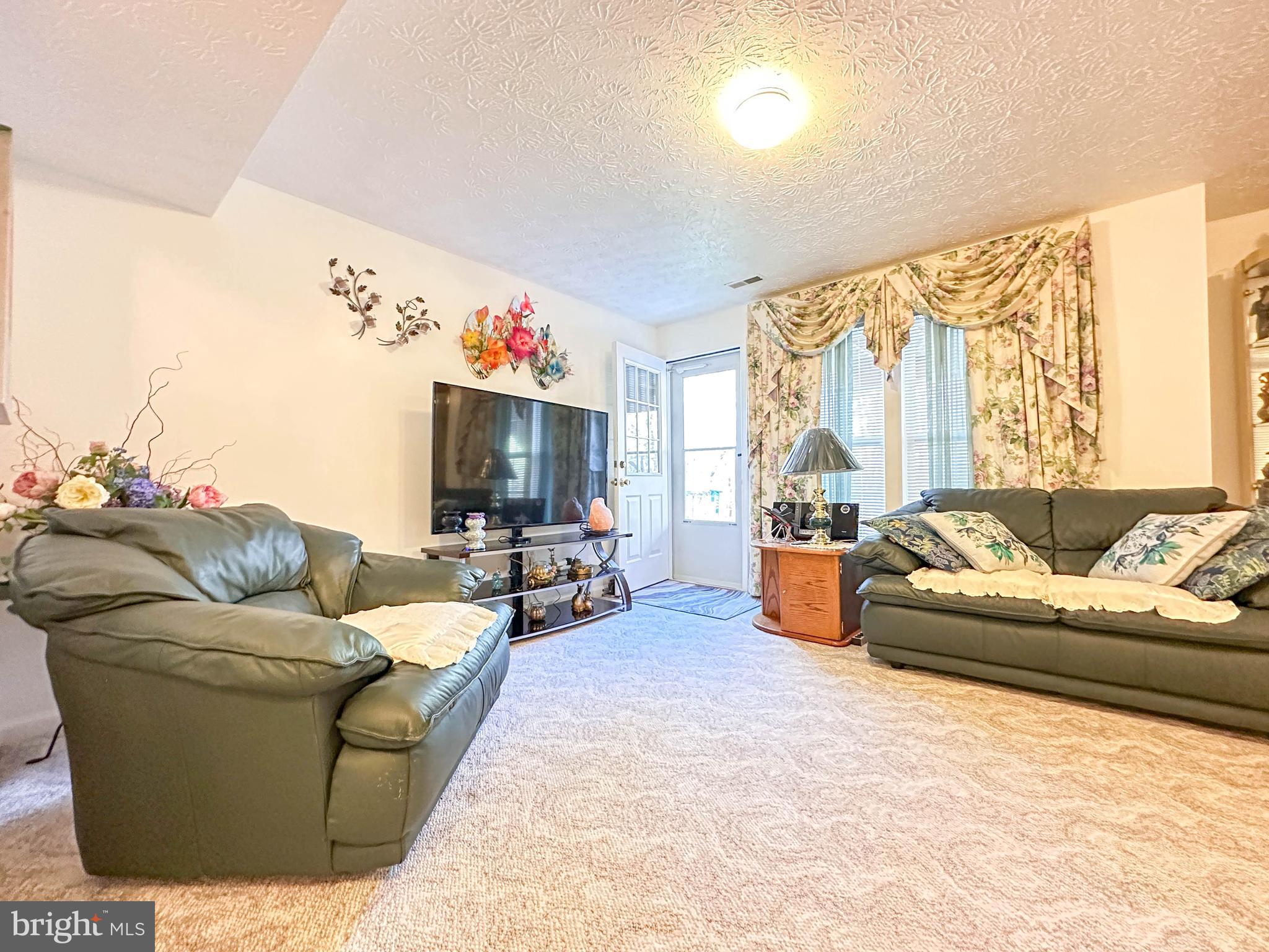 3206 Shadow Park Drive Laurel, MD 20724 - Photo 24 of 28 a living room with furniture and a flat screen tv