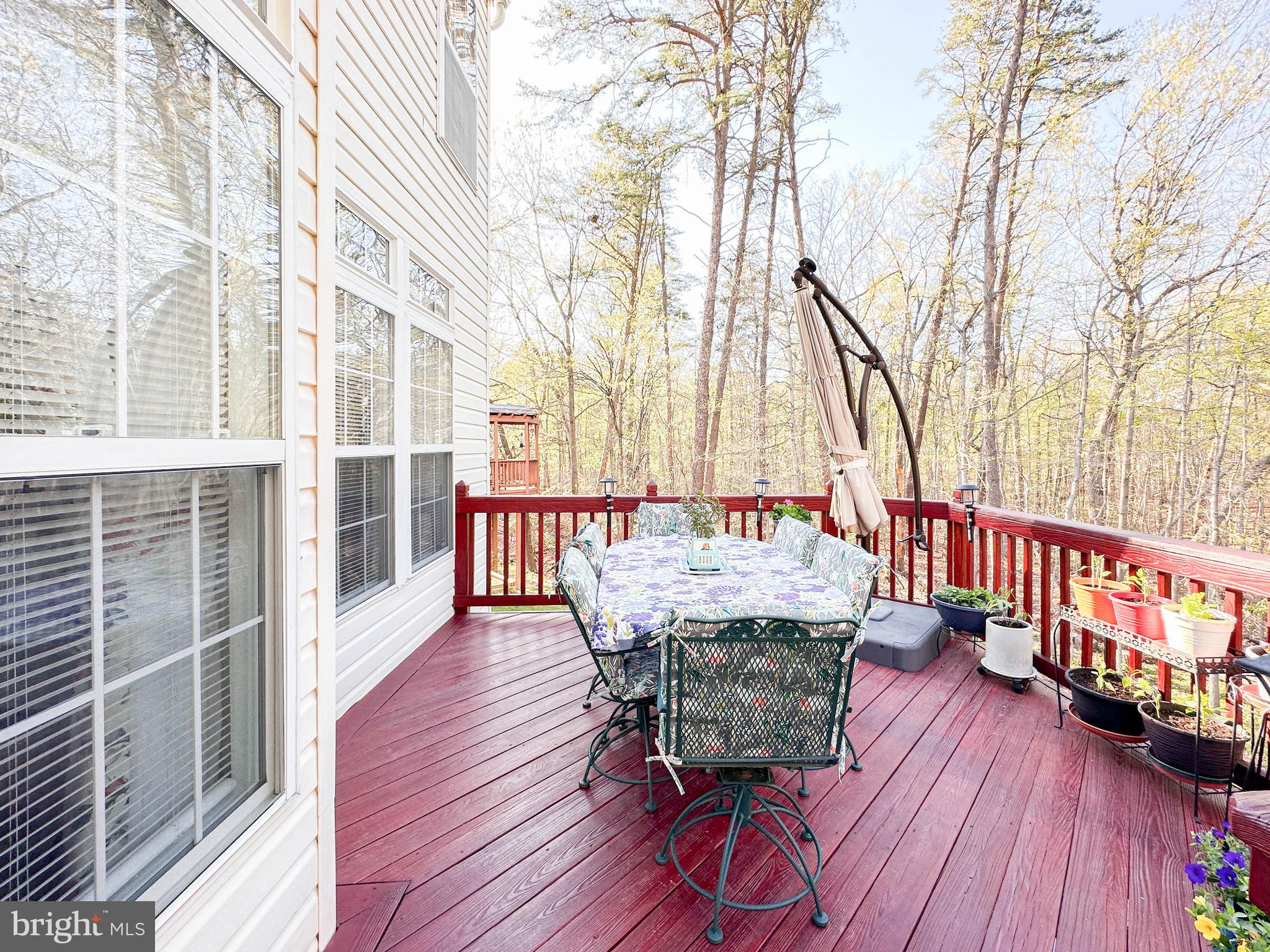 3206 Shadow Park Drive Laurel, MD 20724 - Photo 10 of 28 a balcony with wooden floor and outdoor seating