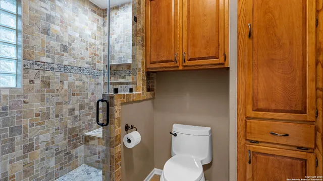a bathroom with a granite countertop shower and a sink