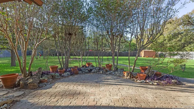 a view of a backyard with a cabin and wooden fence