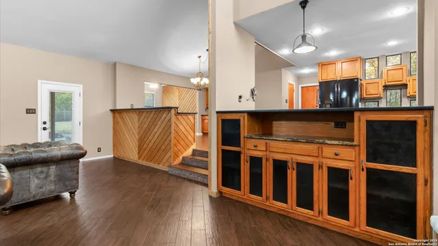 a view of kitchen with stainless steel appliances granite countertop cabinets and wooden floor