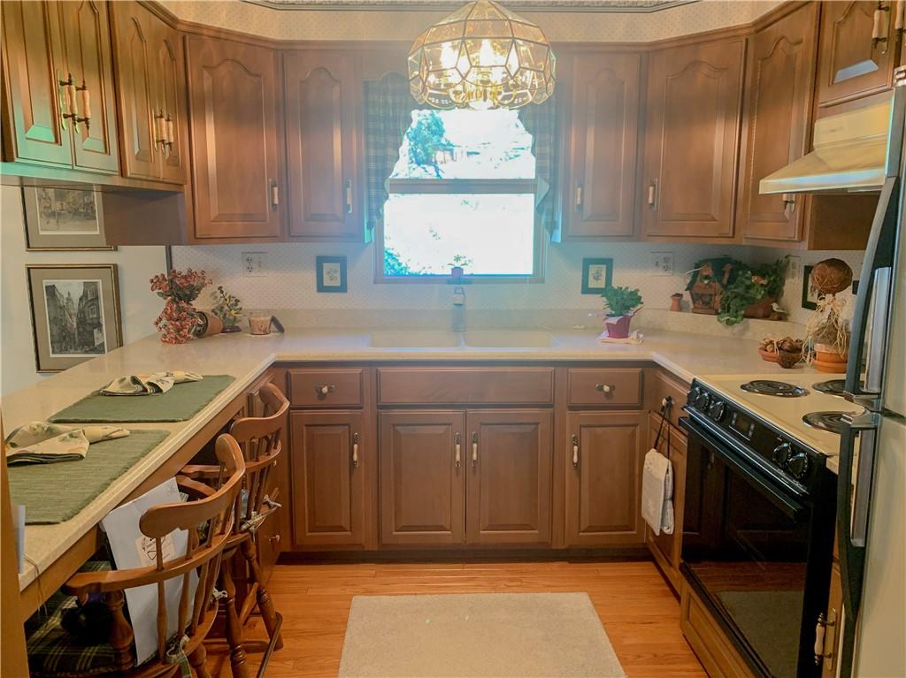 153 State Rte 1035 Kittanning, PA 16201 - Photo 5 of 14 a kitchen with a sink a stove cabinets and a window