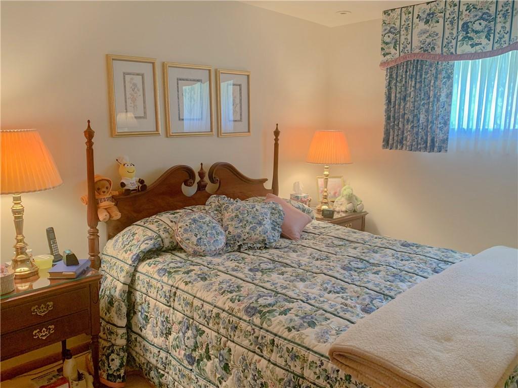 153 State Rte 1035 Kittanning, PA 16201 - Photo 8 of 14 a bedroom with a bed and a lamp on dresser