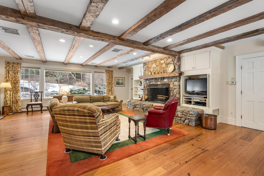 440 Conant Road Weston, MA 02493 - Photo 6 of 15 a living room with furniture a fireplace and a flat screen tv