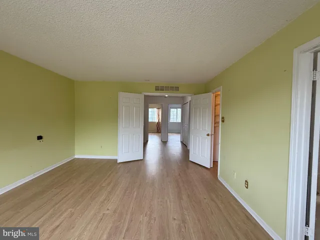 a kitchen with granite countertop a stove a sink and a refrigerator