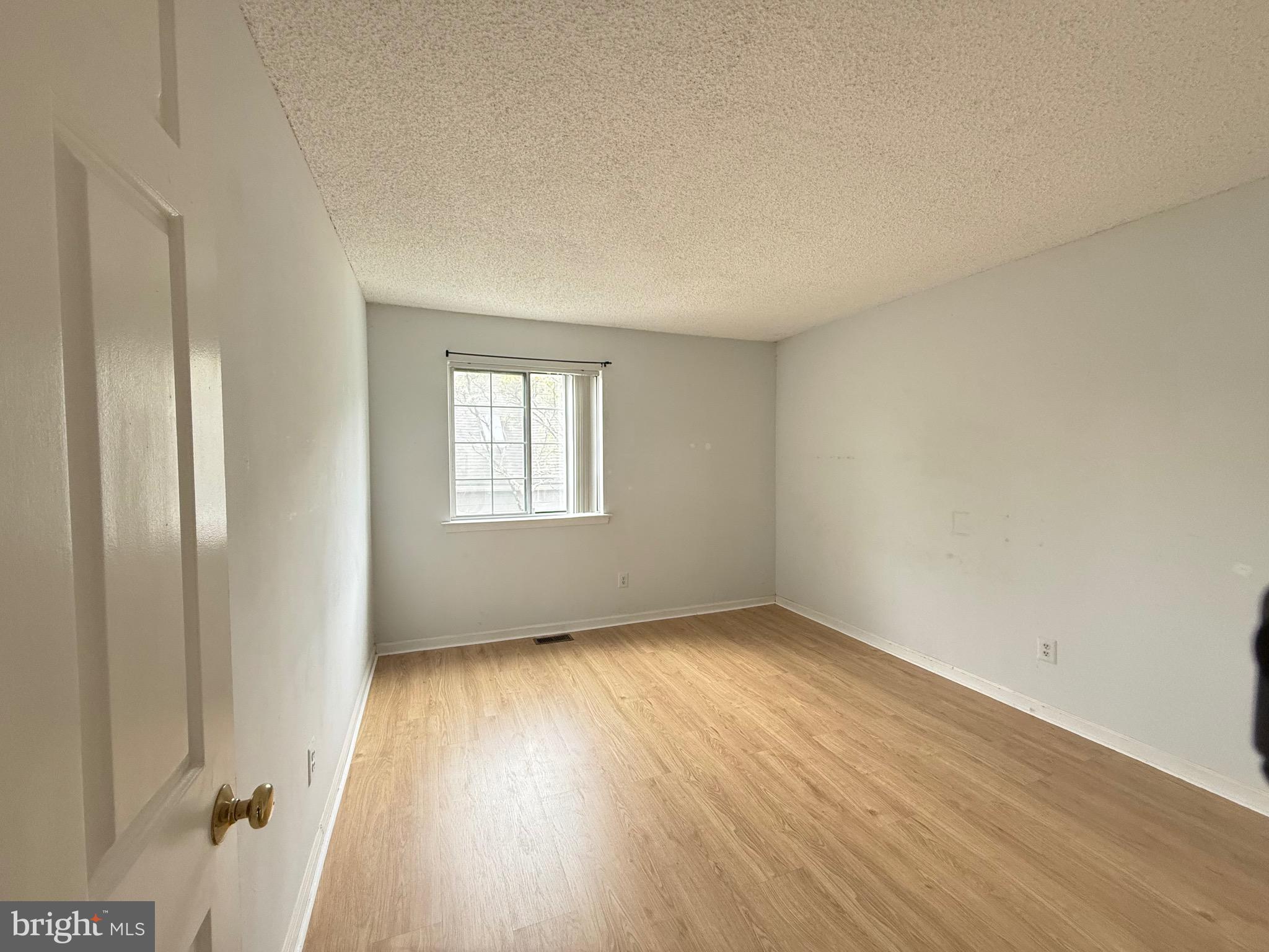 52 Constitution Court Chesterbrook, PA 19087 - Photo 18 of 35 an empty room with wooden floor and windows