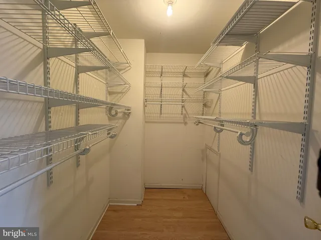 a view of empty room with wooden floor and window
