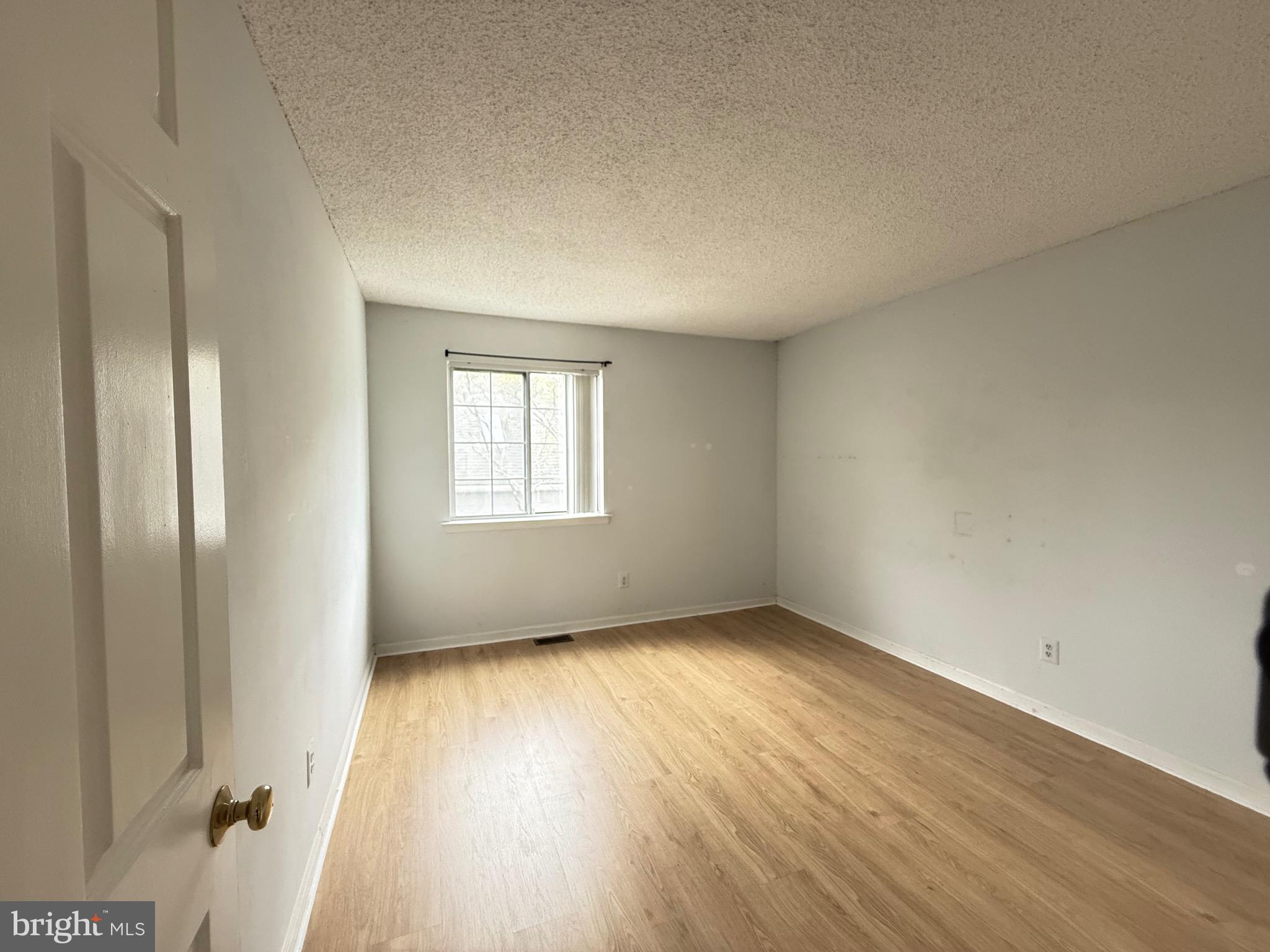 52 Constitution Court Chesterbrook, PA 19087 - Photo 22 of 35 an empty room with wooden floor and windows