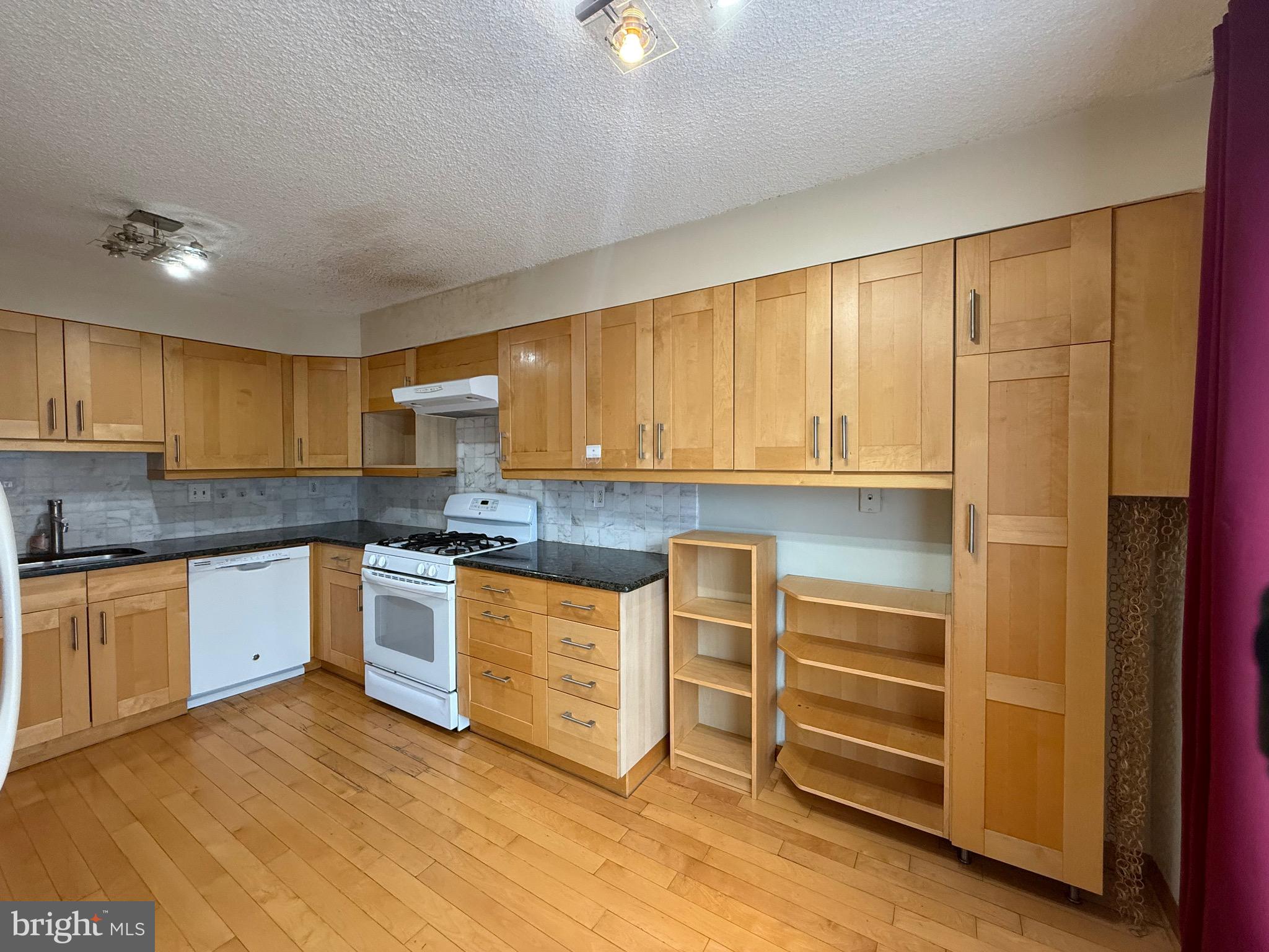 52 Constitution Court Chesterbrook, PA 19087 - Photo 24 of 35 a kitchen with granite countertop a stove a sink and a refrigerator