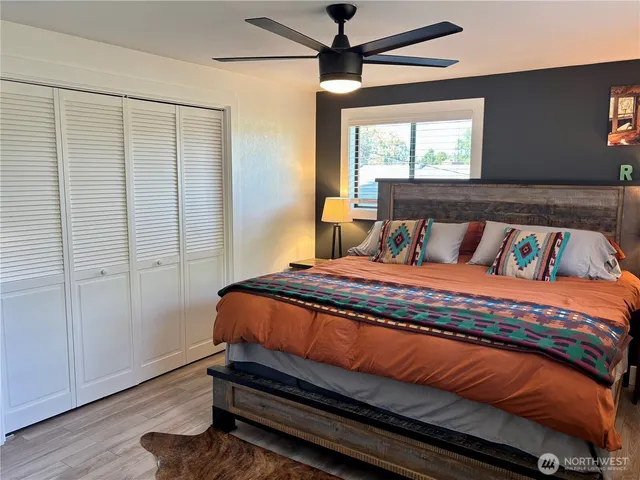a bedroom with a bed and wooden floor