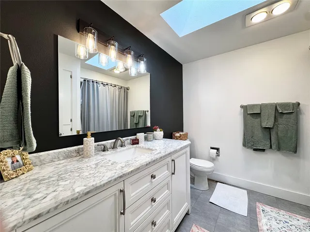 a bathroom with double vanity and a mirror