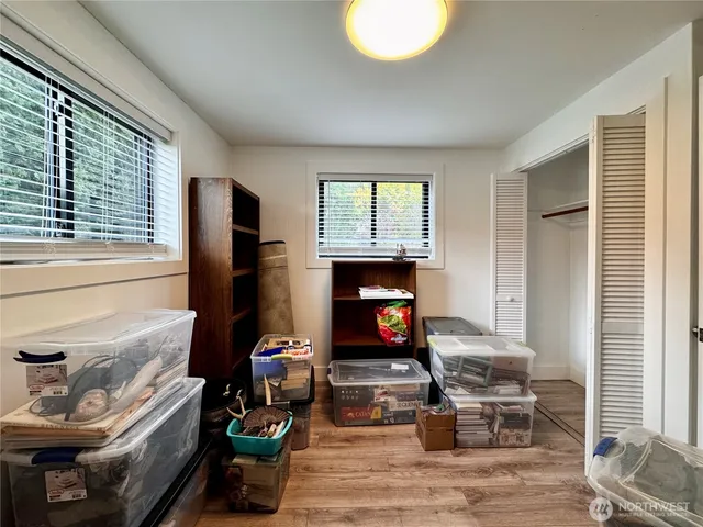 a living room with furniture a flat screen tv and a window