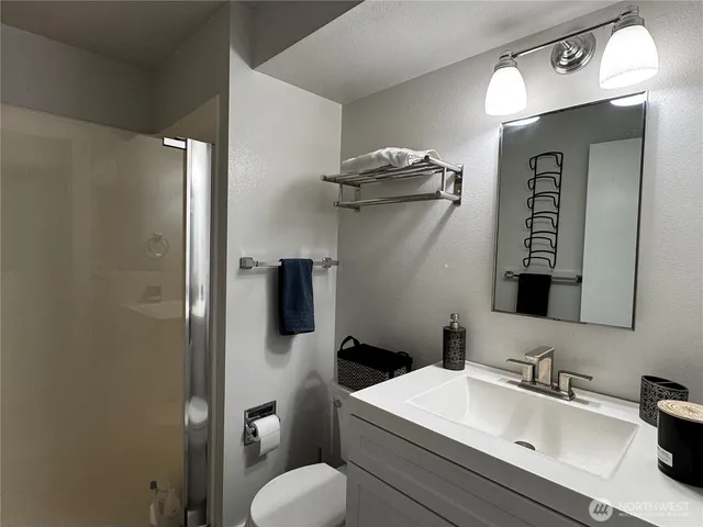 a bathroom with a toilet sink and mirror