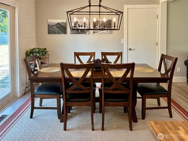 a view of a dining room with furniture and window
