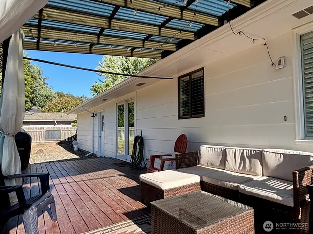 a balcony with wooden floor and furniture