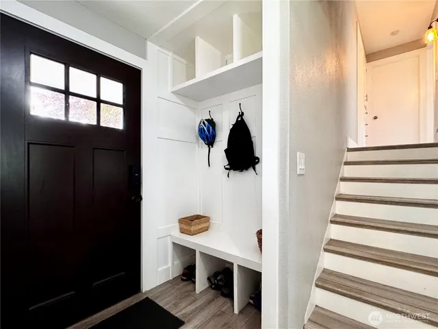 a view of entryway and hall with wooden floor