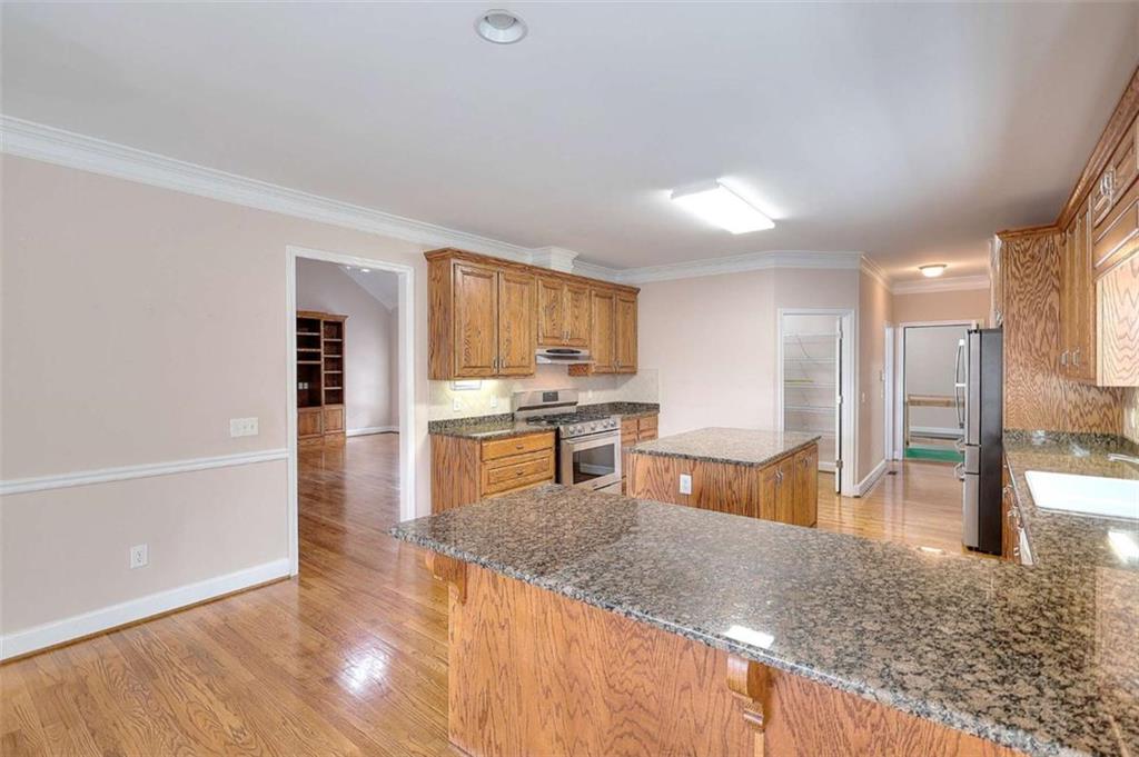 1799 Eliza Doster Road Monroe, GA 30656 - Photo 13 of 60 a kitchen with stainless steel appliances granite countertop a sink stove and refrigerator