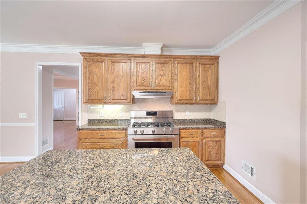 1799 Eliza Doster Road Monroe, GA 30656 - Photo 15 of 60 a kitchen with a stove and a refrigerator