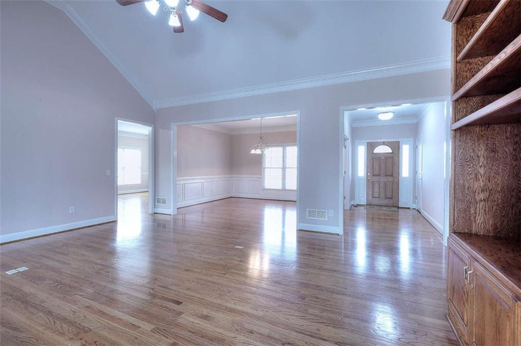 1799 Eliza Doster Road Monroe, GA 30656 - Photo 19 of 60 a view of an empty room with wooden floor and a window