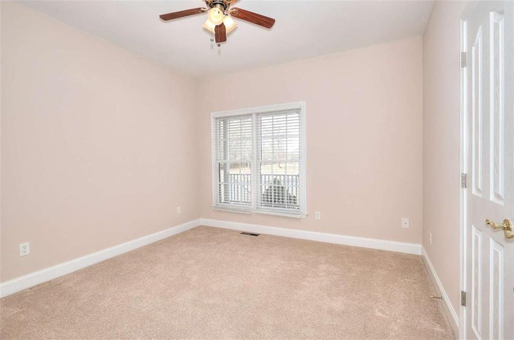 1799 Eliza Doster Road Monroe, GA 30656 - Photo 20 of 60 an empty room with a window and a ceiling fan