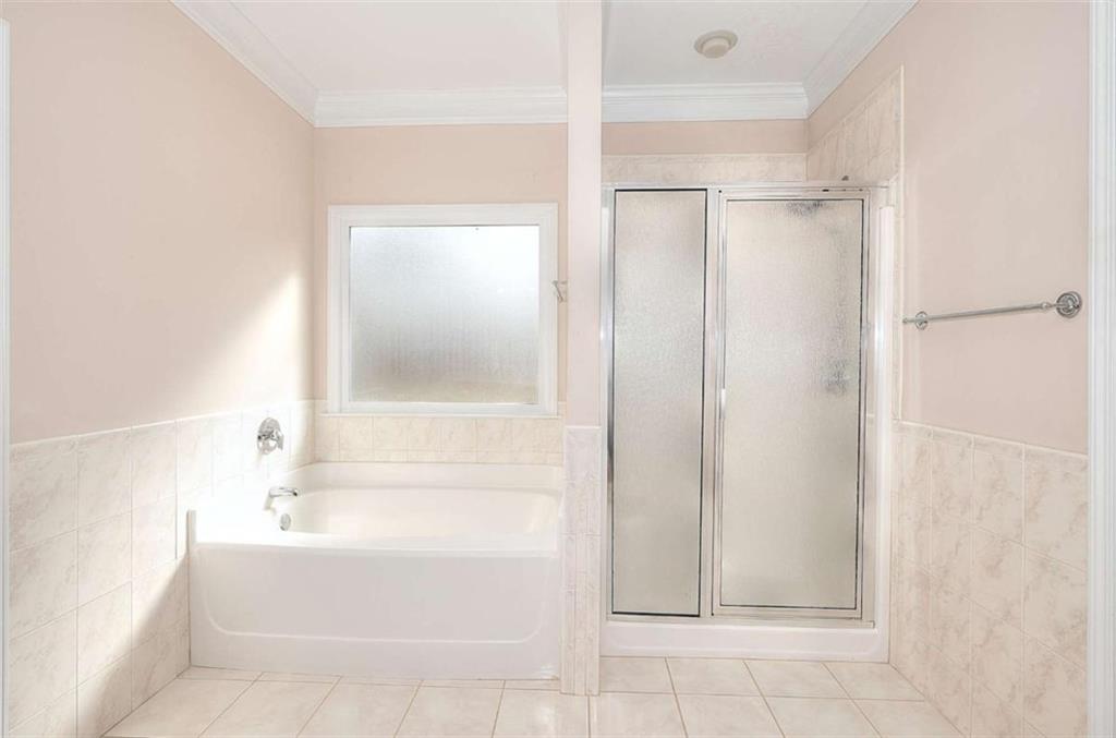 1799 Eliza Doster Road Monroe, GA 30656 - Photo 30 of 60 a bathroom with a bathtub and a shower