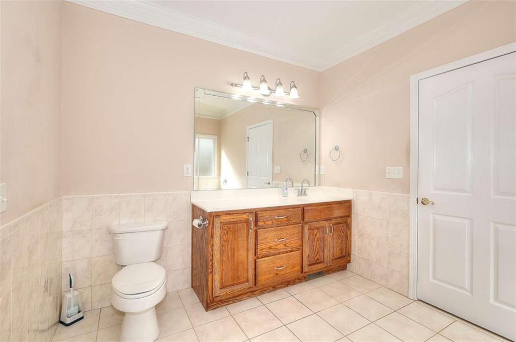 1799 Eliza Doster Road Monroe, GA 30656 - Photo 31 of 60 a bathroom with a toilet sink and mirror