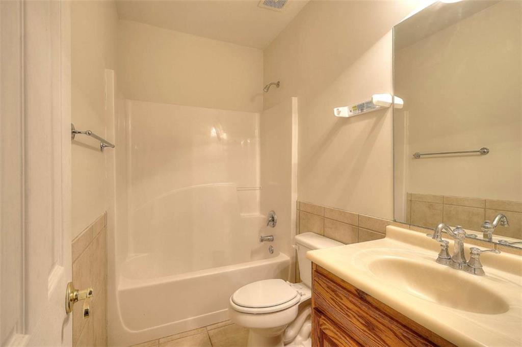 1799 Eliza Doster Road Monroe, GA 30656 - Photo 38 of 60 a bathroom with a sink a toilet and shower