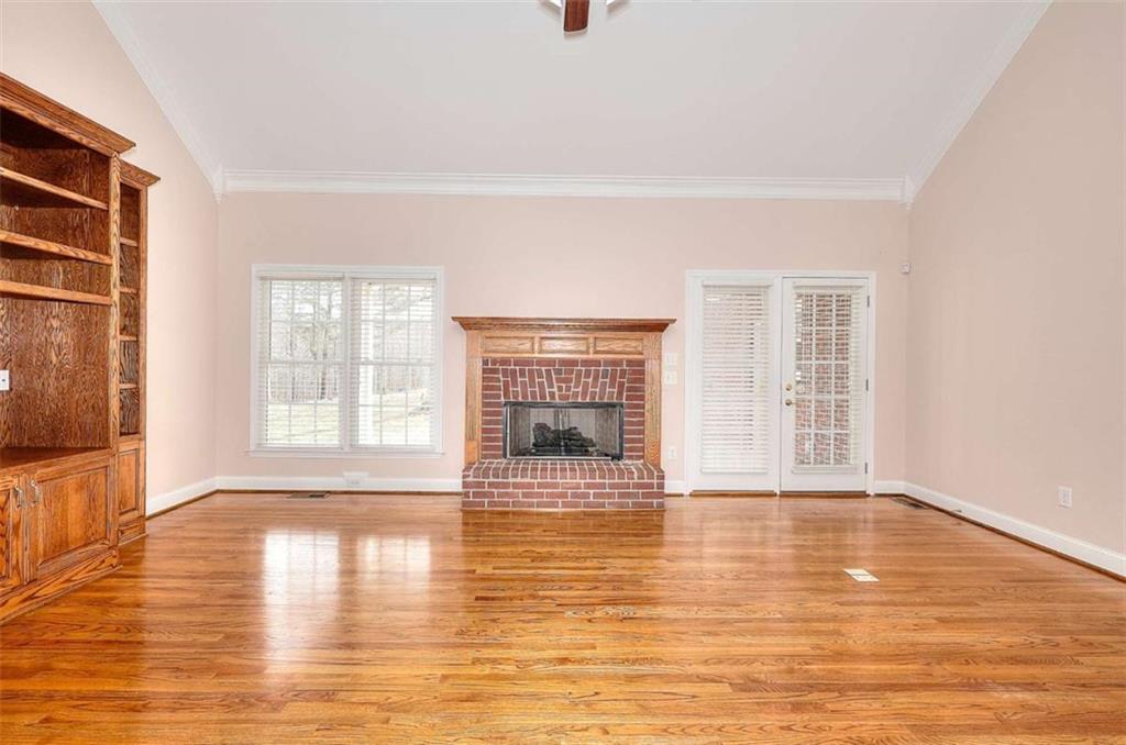 1799 Eliza Doster Road Monroe, GA 30656 - Photo 9 of 60 a view of an empty room with wooden floor and a window