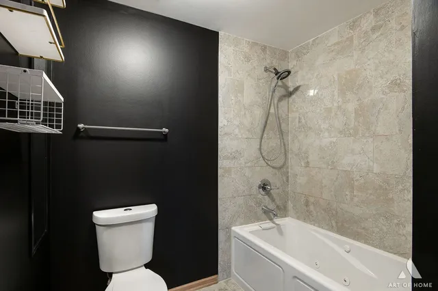 a bathroom with a toilet sink and shower